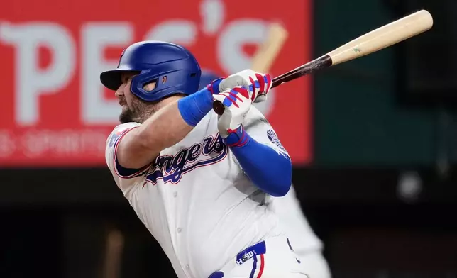 Texas Rangers' Jake Burger connects for a run-scoring single to right in the fifth inning of a baseball game against the Arizona Diamondbacks Tuesday, May 12, 2026, in Arlington, Texas. (AP Photo/Tony Gutierrez)