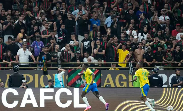 Mamelodi Sundowns' Teboho Mokoena, center, celebrates scoring his side's opening goal during the CAF Champions League final soccer match between AS FAR Rabat and Mamelodi Sundowns, in Rabat, Morocco, Sunday, May 24, 2026. (AP Photo/Mosa'ab Elshamy)
