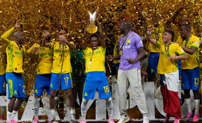 Mamelodi Sundowns' Themba Zwane, center, celebrates with his teammates after winning the CAF Champions League final soccer match between AS FAR Rabat and Mamelodi Sundowns, in Rabat, Morocco, Sunday, May 24, 2026. (AP Photo/Mosa'ab Elshamy)