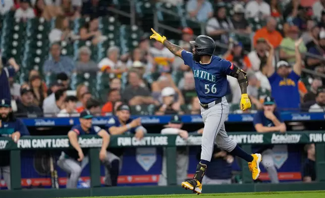 Seattle Mariners' Randy Arozarena celebrates after hitting a two-run home run against the Houston Astros during the second inning of a baseball game Tuesday, May 12, 2026, in Houston. (AP Photo/David J. Phillip)
