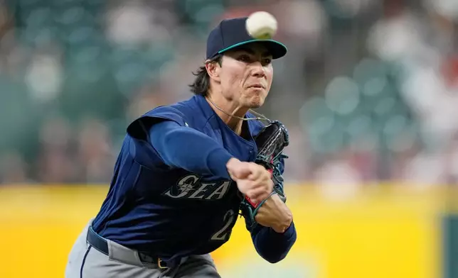 Seattle Mariners starting pitcher Bryan Woo throws against the Houston Astros during the first inning of a baseball game Tuesday, May 12, 2026, in Houston. (AP Photo/David J. Phillip)
