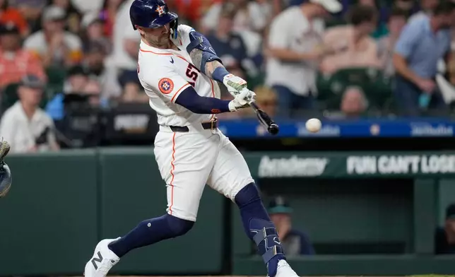 Houston Astros' Christian Walker hits a RBI double against the Seattle Mariners during the third inning of a baseball game Tuesday, May 12, 2026, in Houston. (AP Photo/David J. Phillip)