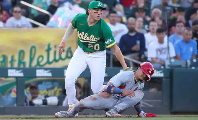 Athletics third baseman Zack Gelof (20) tags out St. Louis Cardinals' Masyn Winn, right, during a rundown during the fourth inning of a baseball game Wednesday, May 13, 2026, in West Sacramento, Calif. (AP Photo/Scott Marshall)