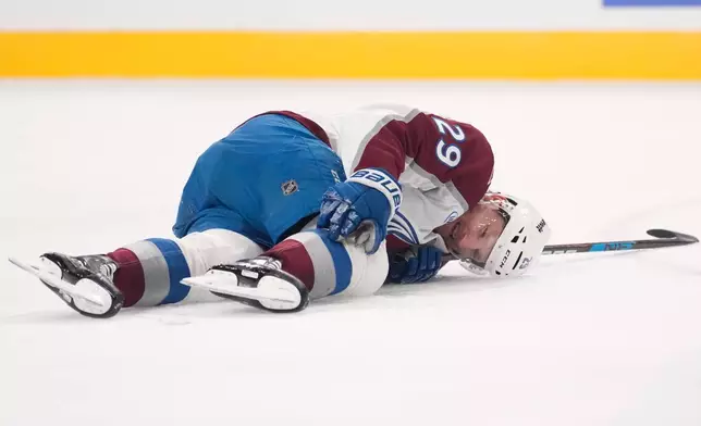 Colorado Avalanche center Nathan MacKinnon lays on the ice after being injured during the second period in Game 3 of the Western Conference finals NHL hockey Stanley Cup playoff series against the Vegas Golden Knights, Sunday, May 24, 2026, in Las Vegas. (AP Photo/Mark J. Terrill)
