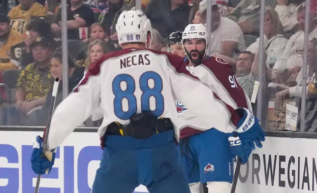 Colorado Avalanche center Nazem Kadri, right, celebrates his goal with center Martin Necas during the first period in Game 3 of the Western Conference finals NHL hockey Stanley Cup playoff series against the Vegas Golden Knights, Sunday, May 24, 2026, in Las Vegas. (AP Photo/Mark J. Terrill)