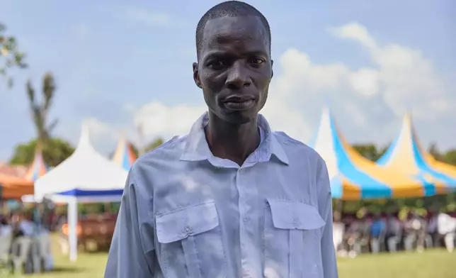 Lawrence Ouma Angira stands during his uncle's funeral and says he finds comfort in having professional mourners present on the outskirts of Kisumu, Kenya, Friday, March 13, 2026. (AP Photo/Asa Wallin)