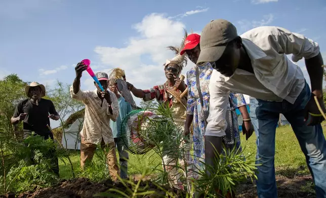 Professional mourners from the Luo community perform a rite of farewell on the outskirts of Kisumu, Kenya, Friday, March 13, 2026. (AP Photo/Asa Wallin)