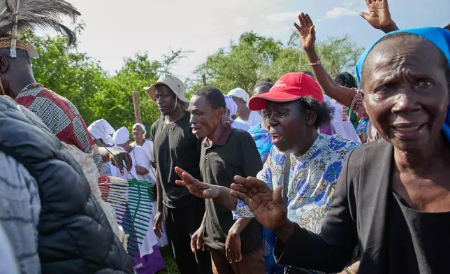 Professional mourners grieve alongside family members and friends of the deceased during a funeral on the outskirts of Kisumu, Kenya, Friday, March 13, 2026. (AP Photo/Asa Wallin)