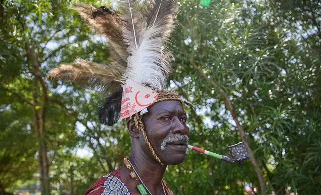 Professional mourner James Ajowi, who has worked in the role for more than 20 years and says the work has taken on deeper meaning since the death of his daughter, stands on the outskirts of Kisumu, Kenya, Friday, March 13, 2026. (AP Photo/Asa Wallin)