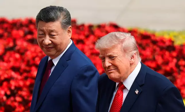 U.S. President Donald Trump, right, and Chinese President Xi Jinping attend a welcome ceremony at the Great Hall of the People in Beijing, Thursday, May 14, 2026. (Maxim Shemetov/Pool Photo via AP)