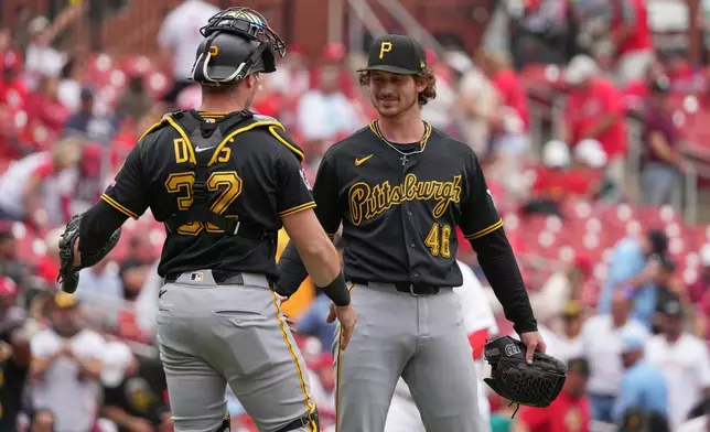 Pittsburgh Pirates' Mason Montgomery (46) and Henry Davis (32) celebrate a victory over the St. Louis Cardinals a baseball game Thursday, May 21, 2026, in St. Louis. (AP Photo/Jeff Roberson)