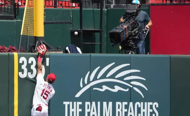 St. Louis Cardinals left fielder Jose Fermin is unable to catch a solo home run by Pittsburgh Pirates' Brandon Lowe during the first inning of a baseball game Thursday, May 21, 2026, in St. Louis. (AP Photo/Jeff Roberson)