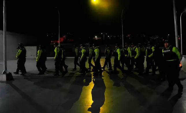 FILE - Police assemble ahead for nighttime curfew patrols as part of a government crackdown on crime in Quito, Ecuador, May 3, 2026. (AP Photo/Dolores Ochoa, File)