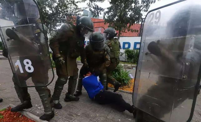 FILE - Police detain a demonstrator during the May Day protest in Santiago, Chile, May 1, 2026. (AP Photo/Luis Hidalgo, File)