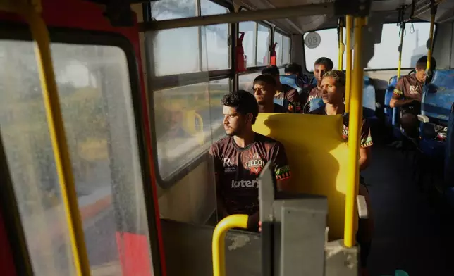 FILE - Players of Originarios, a new soccer team in Rio's fifth division made up exclusively of Indigenous players, ride a bus to practice in Marica, Brazil, April 28, 2026. (AP Photo/Silvia Izquierdo, File)