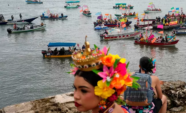 FILE - People wearing traditional pollera conga dress take part in a maritime parade as part of the the 7th Pollera Congo Festival, in Portobelo, Panama, May 2, 2026. (AP Photo/Matias Delacroix, File)