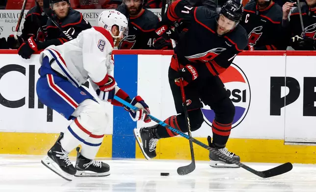 Carolina Hurricanes' Taylor Hall (71) controls the puck with Montréal Canadiens' Mike Matheson (8) nearby during the second period in Game 1 of the Eastern Conference finals NHL hockey Stanley Cup playoffs series in Raleigh, N.C., Thursday, May 21, 2026. (AP Photo/Karl DeBlaker)