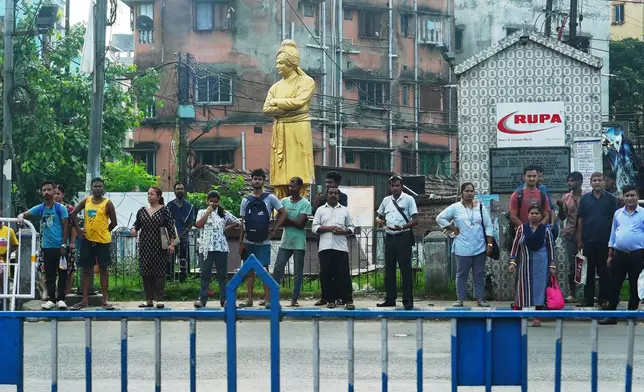 People wait by the side of the road to watch the cavalcade of United States Secretary of State Marco Rubio pass in Kolkata, India, Saturday, May 23, 2026. (AP Photo/Julia Demaree Nikhinson, Pool)