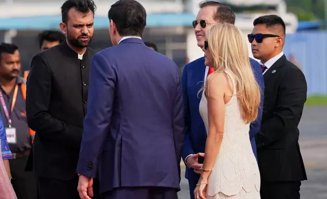 United States Secretary of State Marco Rubio is greeted by West Bengal state's Chief of Protocol, Avadh Singhal, left, after disembarking his plane at Netaji Subhash Chandra Bose International Airport in Kolkata, India, Saturday, May 23, 2026. (AP Photo/Julia Demaree Nikhinson, Pool)
