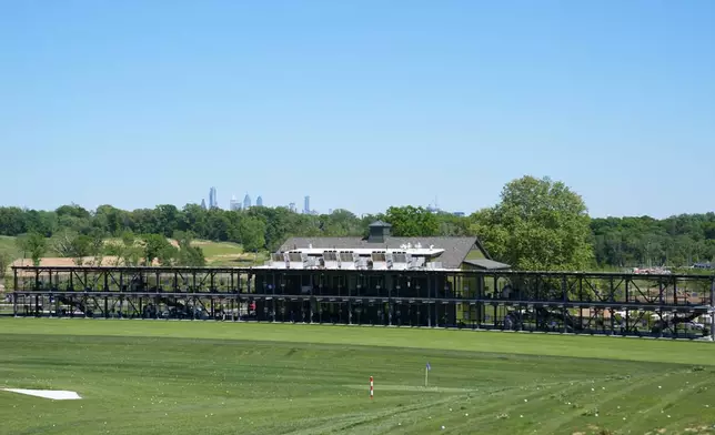 The Philadelphia skyline is seen above the driving range at the Cobbs Creek Golf Club in Philadelphia, Tuesday, May 12, 2026. (AP Photo/Matt Rourke)