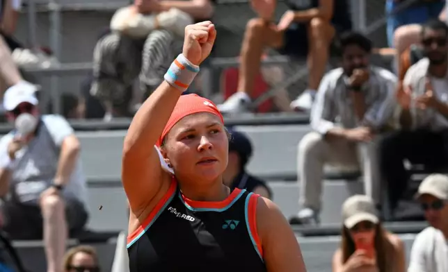 Diana Shnaider of Russia celebrates winning the third round women's singles tennis match against against Oleksandra Oliynykova of Ukraine at the French Open tennis tournament in Paris, Saturday, May 30, 2026. (AP Photo/Emma Da Silva)