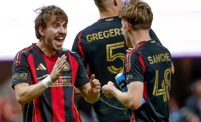 Atlanta United forward Saba Lobjanidze, left, celebrates with midfielder Cooper Sanchez, right after their team defeated CF Montreal in an MLS soccer match, Saturday, May 2, 2026, in Atlanta. (AP Photo/Erik S. Lesser)