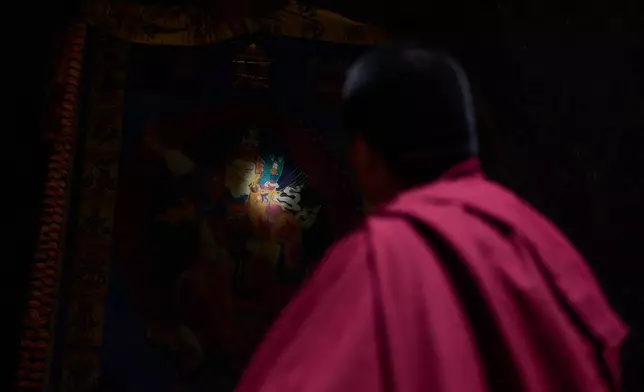 Jalue Dorje looks at a painting inside Maratika Caves, 135 miles east from Kathmandu, Nepal, Monday, April 13, 2026. (AP Photo/Niranjan Shrestha)