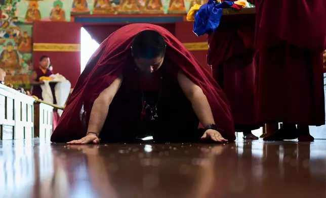 Jalue Dorje offers prayers during a ritual with other monks at Dzarong Thubten Mindrol Dongä Monastery in Kathmandu, Nepal, Tuesday, April 14, 2026. (AP Photo/Niranjan Shrestha)