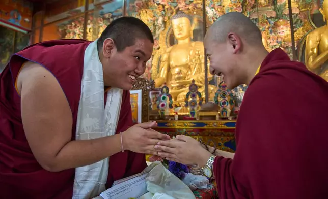 Jalue Dorje greets his friend and fellow monk, Trulshik Yangsi Rinpoche, during a ritual at Shechen Monastery in Kathmandu, Nepal, Tuesday, April 7, 2026. (AP Photo/Niranjan Shrestha)