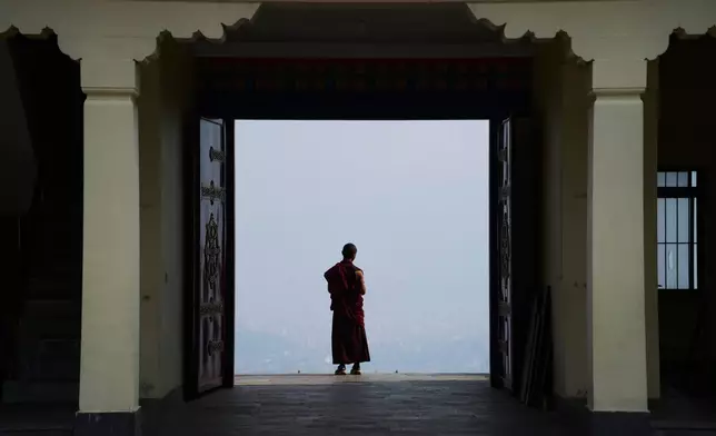 A Buddhist monk takes a break from a ritual at Dzarong Thubten Mindrol Dongä Monastery in Kathmandu, Nepal, Tuesday, April 14, 2026. (AP Photo/Niranjan Shrestha)