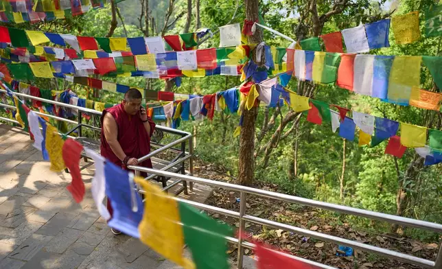 Jalue Dorje speaks on the phone during a visit to Maratika Caves, in eastern Nepal, Monday, April 13, 2026. (AP Photo/Niranjan Shrestha)