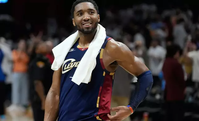 Cleveland Cavaliers guard Donovan Mitchell (45) smiles as fans cheer while he is interviewed after the Cavaliers defeated the Detroit Pistons in Game 3 of a second-round NBA playoffs basketball series Saturday, May 9, 2026 in Cleveland. (AP Photo/Sue Ogrocki)