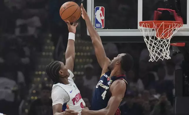 Detroit Pistons guard Ausar Thompson (9) shoots as Cleveland Cavaliers center Evan Mobley (4) defends in the first half of Game 3 of a second-round NBA playoffs basketball series Saturday, May 9, 2026 in Cleveland. (AP Photo/Sue Ogrocki)