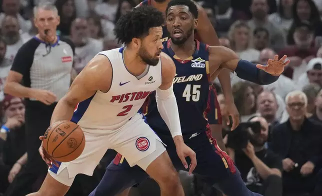 Detroit Pistons guard Cade Cunningham (2) drives against Cleveland Cavaliers guard Donovan Mitchell (45) in the first half of Game 3 of a second-round NBA playoffs basketball series Saturday, May 9, 2026 in Cleveland. (AP Photo/Sue Ogrocki)