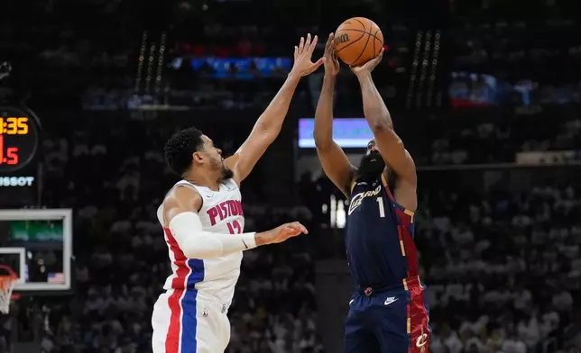Cleveland Cavaliers guard James Harden (1) shoots as Detroit Pistons forward Tobias Harris (12) defends in the first half of Game 3 of a second-round NBA playoffs basketball series Saturday, May 9, 2026 in Cleveland. (AP Photo/Sue Ogrocki)