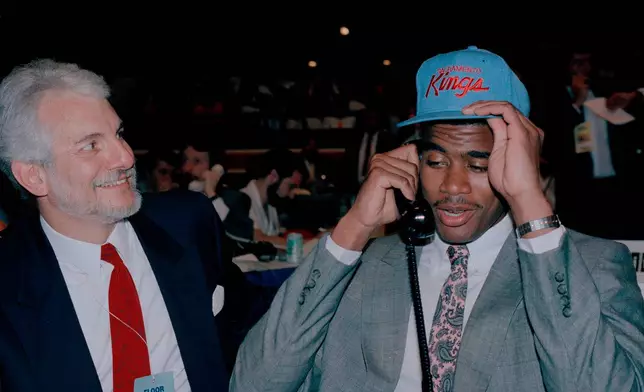 FILE - Sacramento Kings Jim Kerman, left, smiles as the NBA's No. 1 draft choice, Pervis Ellison, adjusts his new cap at the NBA Draft in New York, June 28, 1989. (AP Photo/Ron Frehm, File)
