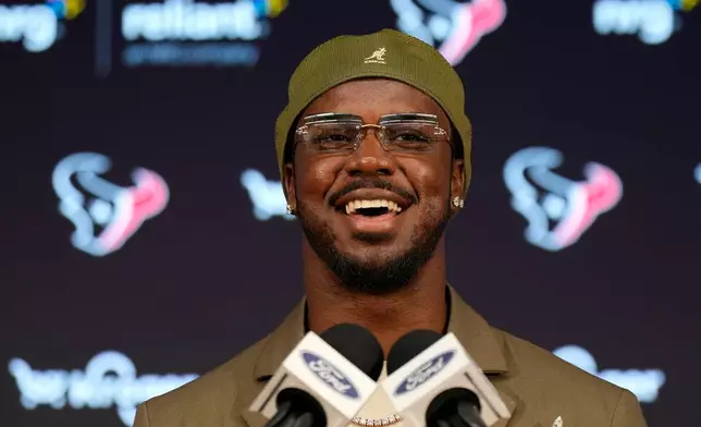 Houston Texans' Azeez Al-Shaair talks about his contract extension during a press conference at the NFL football team's facility, Friday, May 1, 2026, in Houston. (AP Photo/Karen Warren)