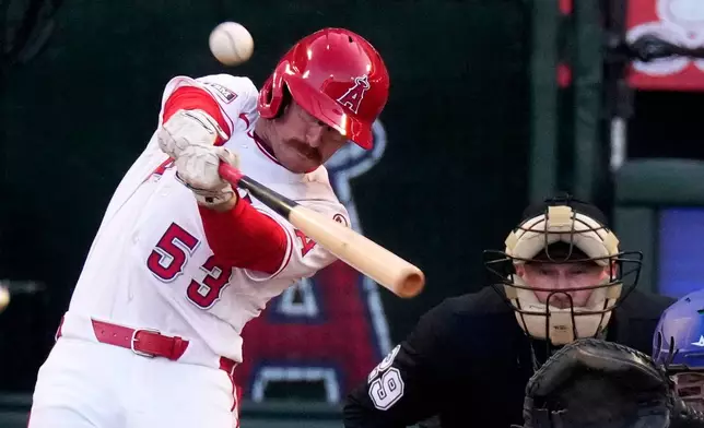 Los Angeles Angels' Wade Meckler, left, hits a three-run home run home plate as umpire Sean Barber watches during the first inning of a baseball game against the Texas Rangers, Friday, May 22, 2026, in Anaheim, Calif. (AP Photo/Mark J. Terrill)