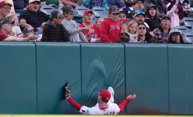 Los Angeles Angels left fielder Wade Meckler slides into the wall after making a catch on a foul ball hit by Texas Rangers' Brandon Nimmo during the first inning of a baseball game Friday, May 22, 2026, in Anaheim, Calif. (AP Photo/Mark J. Terrill)