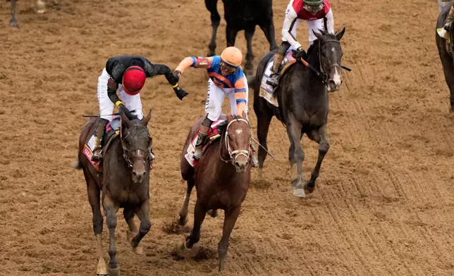 Jockey Jose L. Ortiz, left, is congratulated by Irad Ortiz, Jr. atop Renegade, after riding Golden Tempo to victory during the 152nd running of the Kentucky Derby horse race at Churchill Downs, Saturday, May 2, 2026, in Louisville, Ky. (AP Photo/Charlie Riedel)