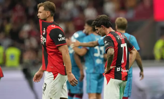 AC Milan's Christian Pulisic, right, reacts with his teammate Niclas Fuellkrug at the end the Serie A soccer match between AC Milan and Cagliari, in Milan, Italy, Sunday, May 24, 2026. (AP Photo/Antonio Calanni)