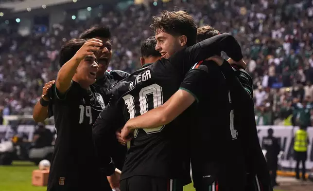 Mexico's Brian Gutiérrez, right, is congratulated after scoring his side's opening goal against Ghana during an international friendly soccer match in Puebla, Mexico, Friday, May 22, 2026. (AP Photo/Fernando Llano)