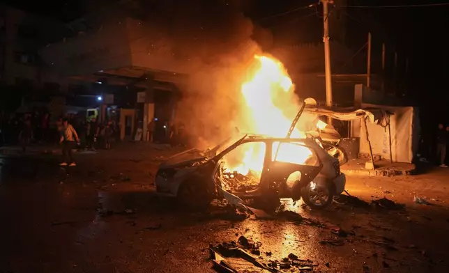 Flames engulf a vehicle struck by an Israeli strike in a street of Gaza City, Friday, May 15, 2026. (AP Photo/Jehad Alshrafi)