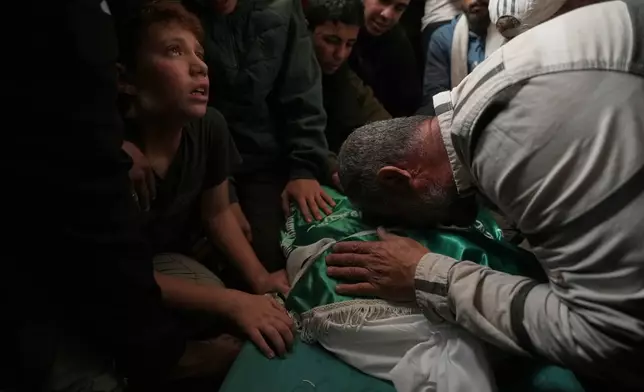 Palestinians mourn over the body of Izz al-Din al-Haddad, the leader of Hamas' Qassam Brigades, during his funeral in Gaza City, Saturday, May 16, 2026. (AP Photo/Jehad Alshrafi)