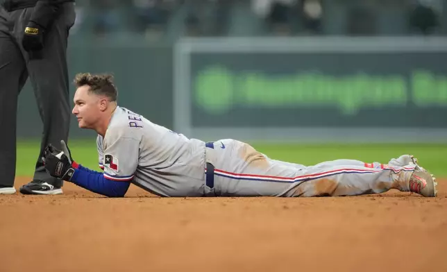 Texas Rangers' Joc Pederson reacts after being put out at second base while trying to stretch a single into a double in the third inning of a baseball game against the Colorado Rockies, Tuesday, May 19, 2026, in Denver. (AP Photo/David Zalubowski)