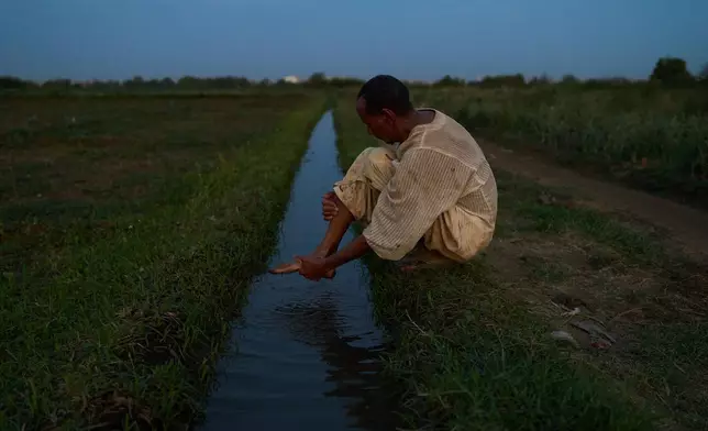 Farmer Omer al Hassan washes his feet before Muslim prayer in Omdurman, Sudan, Saturday, April 25, 2026. (AP Photo/Bernat Armangue)