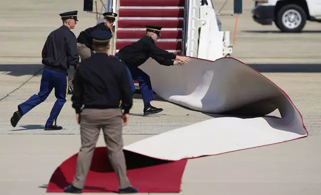 The red carpet blows in the wind before Britain's King Charles III and Queen Camilla depart from Joint Base Andrews, Md., Thursday, April 30, 2026. (AP Photo/Jose Luis Magana)