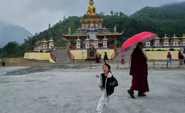 A girl plays at the Jigaon monastery in Sherdukpen village in West Kameng, Arunachal Pradeshin, India, Sunday, April 26, 2026. (AP Photo/Anupam Nath)