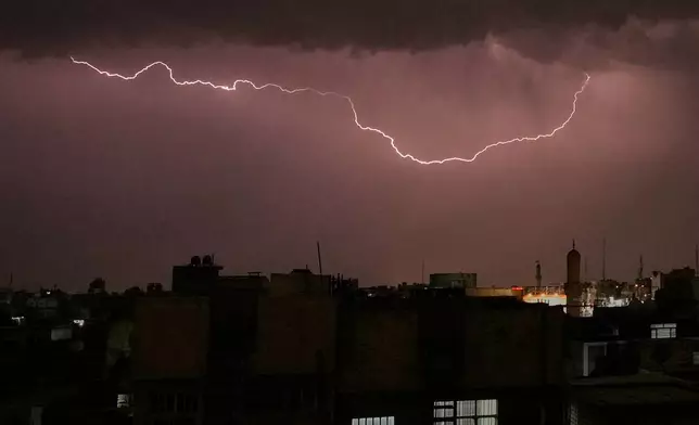 Lightning lights up the sky as a thunderstorm moves through Baghdad, Iraq, Sunday, April 26, 2026. (AP Photo/Hadi Mizban)