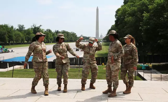 Members of the District of Colombia Air National Guard are seen dancing at the Lincoln Memorial, Friday, April 24, 2026, in Washington. The Washington Monument is seen in the background. (AP Photo/Rahmat Gul)